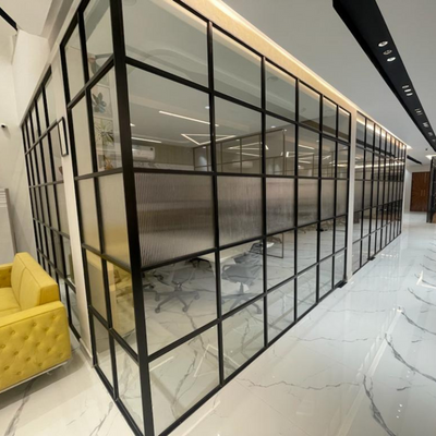 Modern office interior featuring a sleek slimline glass partition for stylish and functional space division.